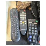 Collection of Xfinity Modems, Cisco Cable Boxes, USB Charger, Remotes, and Decorative Clock