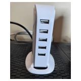 Collection of Xfinity Modems, Cisco Cable Boxes, USB Charger, Remotes, and Decorative Clock