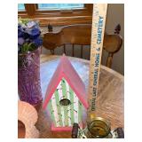 Assorted Collectibles: Porcelain Dolls, Glass Hen Dish, Birdhouse, and Decorative Figurines