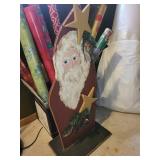 Collection of Holiday Wrapping Paper Rolls and Wooden Santa Holder