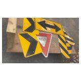 Collection of Used Road Signs Including Yield and Directional Arrows