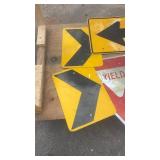 Collection of Used Road Signs Including Yield and Directional Arrows