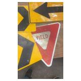 Collection of Used Road Signs Including Yield and Directional Arrows