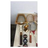 Vintage Tennis Racket Collection with Hockey Pucks and Trophy