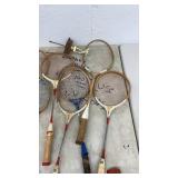 Vintage Tennis Racket Collection with Hockey Pucks and Trophy