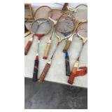 Vintage Tennis Racket Collection with Hockey Pucks and Trophy