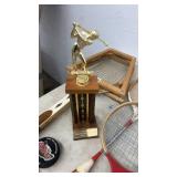 Vintage Tennis Racket Collection with Hockey Pucks and Trophy