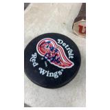 Vintage Tennis Racket Collection with Hockey Pucks and Trophy