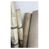 Collection of Assorted Rolled Carpets and Remnants