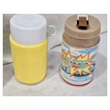 Lot of Vintage Lunch Box Thermo Bottles Featuring Various Designs such as Aladdin and Sesame Street