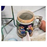 Assorted vintage decorative items including a Atlantic Mold Ceramic Victorian shoe, USA Ceramic Pitcher, Mango Wood Container, beer stein and More