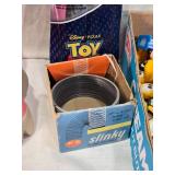 Lot of Vintage Toys and Collectibles including Little Tikes Piggy Bank, Toy Story Kite, and Trading Cards Like PukeMon