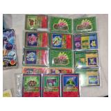 Lot of Vintage Toys and Collectibles including Little Tikes Piggy Bank, Toy Story Kite, and Trading Cards Like PukeMon