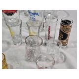 Lot of Various Glassware and Mugs Including Tuborg Gold Mug, White Horse Whiskey Pitcher, and Lind