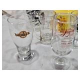 Lot of Various Glassware and Mugs Including Tuborg Gold Mug, White Horse Whiskey Pitcher, and Lind