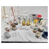 Assorted mugs and glasses including Kimball MN glass mug, Lutsen Glass, Oakley National Bank, Budweiser mugs, and various commemorative mugs