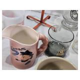 Assorted mugs and glasses including Kimball MN glass mug, Lutsen Glass, Oakley National Bank, Budweiser mugs, and various commemorative mugs