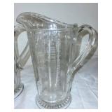 Pair of Antique Glass Measuring Pitchers with Embossed Measurements