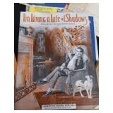 2 VINTAGE BRASS FRENCH HORNS PLUS SHEET MUSIC.