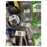 Collection of Garden Tools and Accessories Including Spiral Anchoring Spikes, Nozzles, and Light