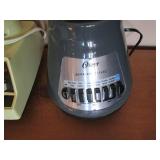 Vintage and modern blenders each wi...