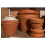 G  - Collection of Mixed Clay and Plastic Flower Pots and Saucers