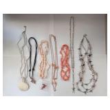 Collection of 7 Vintage Beaded and Shell Necklaces with Religious and Animal Charms