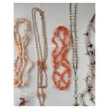 Collection of 7 Vintage Beaded and Shell Necklaces with Religious and Animal Charms