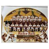 University of Minesota Mini Hockey Sticks Autographed by Head Coach Dan Lucia, 2002/2003 Back to Back Championship Poster Autographed by Thomas Vanek and Gopher Hockey Puck