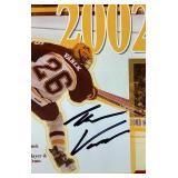 University of Minesota Mini Hockey Sticks Autographed by Head Coach Dan Lucia, 2002/2003 Back to Back Championship Poster Autographed by Thomas Vanek and Gopher Hockey Puck