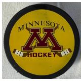 University of Minesota Mini Hockey Sticks Autographed by Head Coach Dan Lucia, 2002/2003 Back to Back Championship Poster Autographed by Thomas Vanek and Gopher Hockey Puck