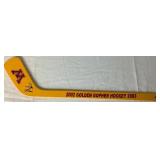 University of Minesota Mini Hockey Sticks Autographed by Head Coach Dan Lucia, 2002/2003 Back to Back Championship Poster Autographed by Thomas Vanek and Gopher Hockey Puck