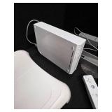 Nintendo Wii console with a Wii Balance Board and various accessories