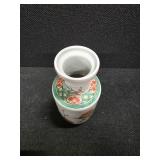 Chinese Porcelain Vase depicting flowers, vines and a little green bird