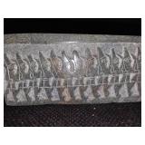 Cambodian stone artifact depicting carvings of an ancient race.