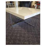 A  white cocktail/coffee table with chrome legs by A.L.F. Italy.