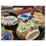 A lot of 27 Snuff Bottles. 8 bottles are missing their stops. Cinnabar. Painted. Etc.