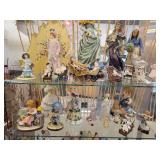 A Six Shelf Glass Display Case including all contents shown in pictures.