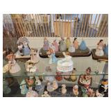 A Six Shelf Glass Display Case including all contents shown in pictures.