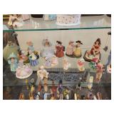 A Six Shelf Glass Display Case including all contents shown in pictures.