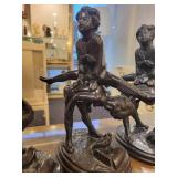A group of 4 Bronze Statues.  Children Leapfrogging and Blindfolded Girl.