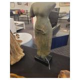 A table full of decor items, animal figures, pottery, glassware, bookends, candle holders, dolls etc.