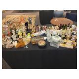A table full of Porcelain Shoes, Figurines, Music and plain Boxes, Collectibles etc.