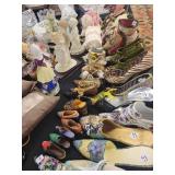 A table full of Porcelain Shoes, Figurines, Music and plain Boxes, Collectibles etc.