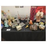 A table full of Figurines, Dolls, Glassware, Leaded Glass Sconce Cover, China, Perfumes etc.