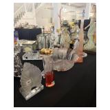 A table full of Figurines, Dolls, Glassware, Leaded Glass Sconce Cover, China, Perfumes etc.