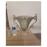 A Silver Raised Design Plant Stand with an angel and flowers, and a handled Vase / Bowl.