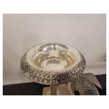 A Silver Raised Design Plant Stand with an angel and flowers, and a handled Vase / Bowl.