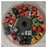 LR - Collection of Hot Wheels Cars in 7 Round Containers Including McDonalds, Quaker State, Firebird and More