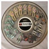 LR - Collection of Hot Wheels Cars in 7 Round Containers Including McDonalds, Quaker State, Firebird and More